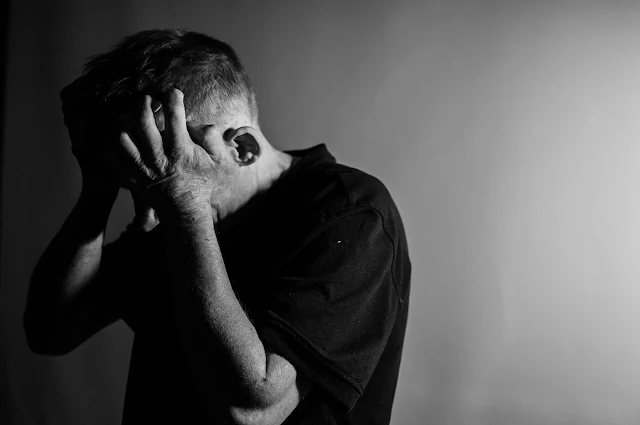 man looking sad lost and desperate in black and white