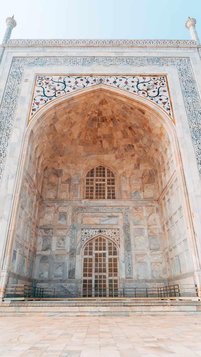 A close-up view of an ornate marble archway with intricate carvings and detailed mosaic patterns, reflecting traditional building techniques.