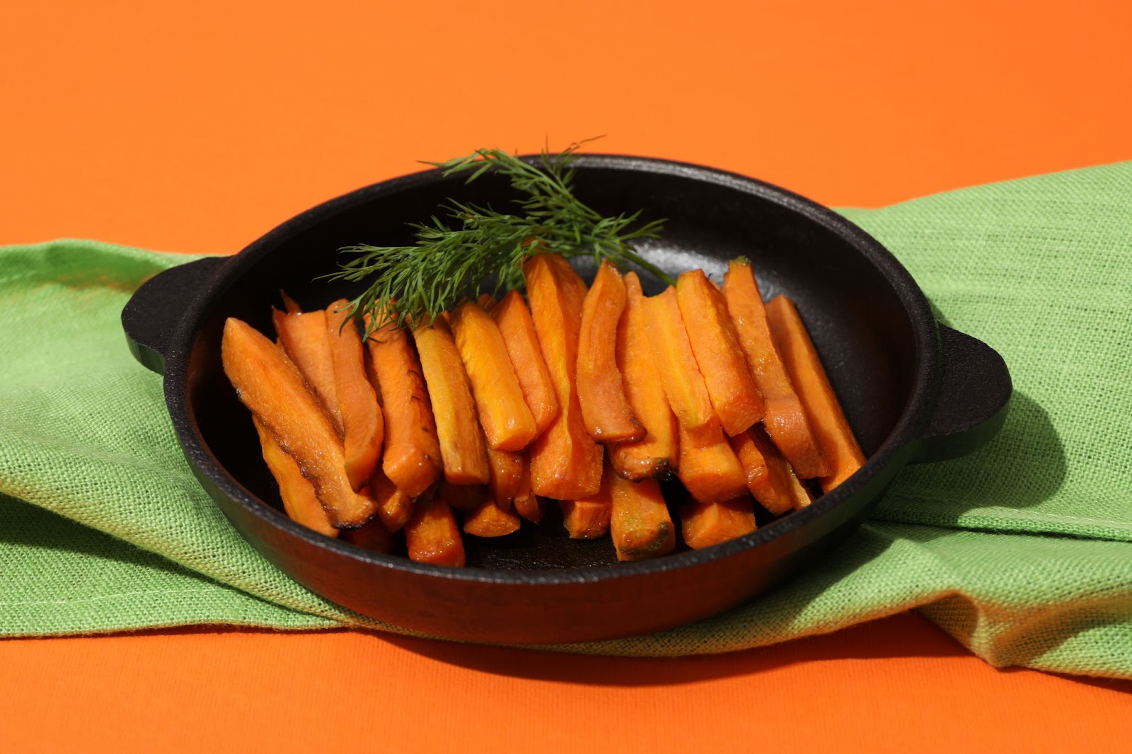 A bowl of roasted carrot sticks