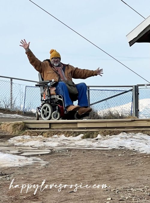 man in wheelchair at top of mountain