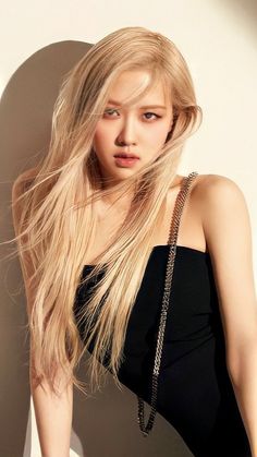 This contain Rosé with long blonde hair wearing a black dress and holding a purse in her hand