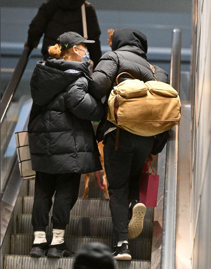 Ariana Grande and Ethan Slater hold hands, carry gifts at NYC airport