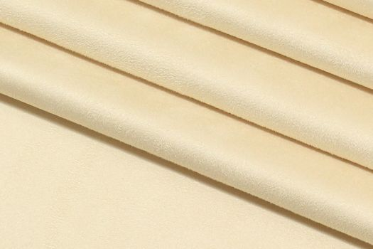 A close-up of a light beige polyester blend fabric.