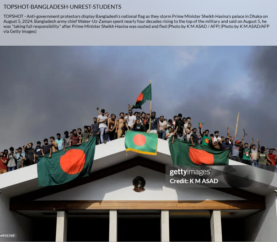 Anti-government protesters wave Bangladesh's national flag as they invade Prime Minister Sheikh Hasina's palace in Dhaka