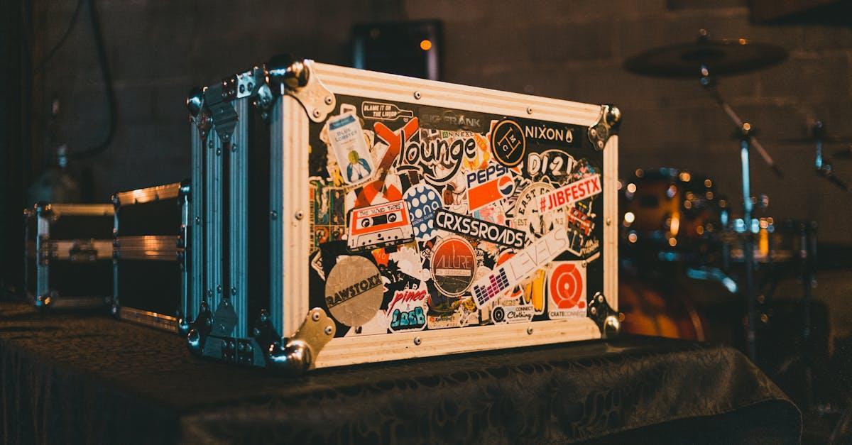 A music equipment case covered in colorful stickers in a studio setting, ideal for creative projects.