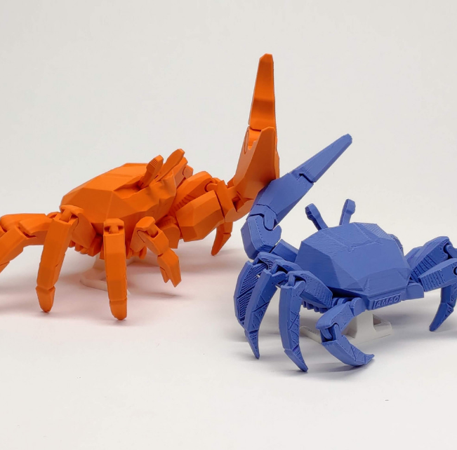 Realistic 3D printed fiddler crab automata with a large movable claw, capturing natural marine life movement.