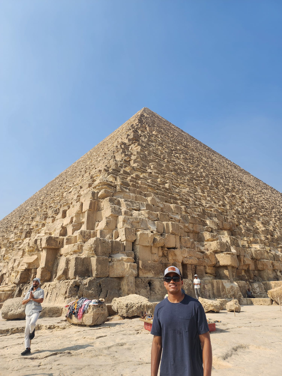 Man smiling in front of an Egyptian pyramid