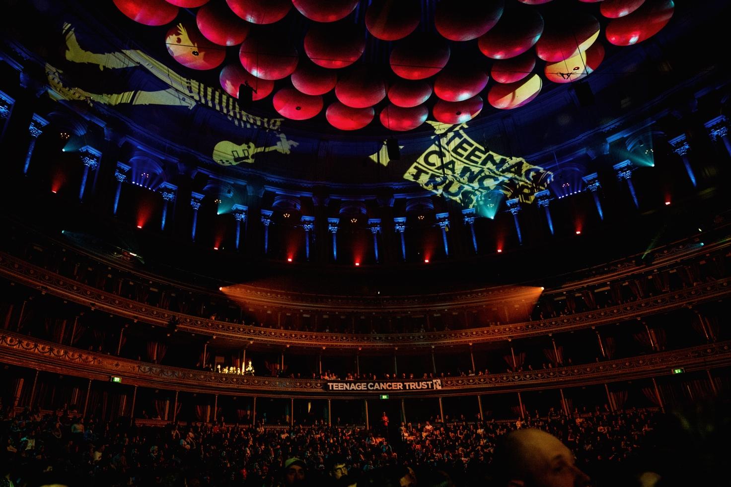 A large crowd of people in a concert hall Description automatically generated