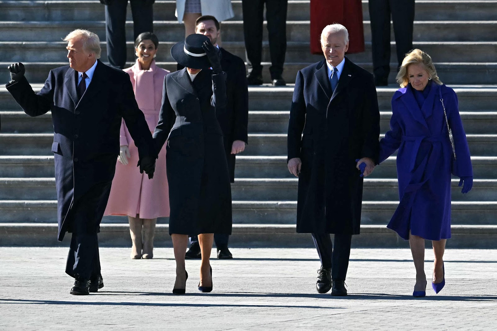 Donald and Melania Trump walking alongside Joe and Jill Biden with Usha and J.D. Vance behind them during a farewell ceremony. | Source: Getty Images