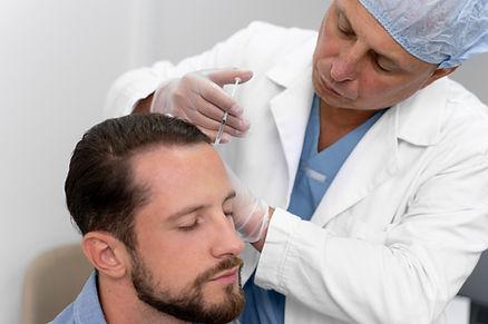 A doctor is injecting syringe to his patient