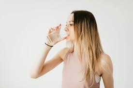 Young woman drinking glass of cold pure water · Free Stock Photo