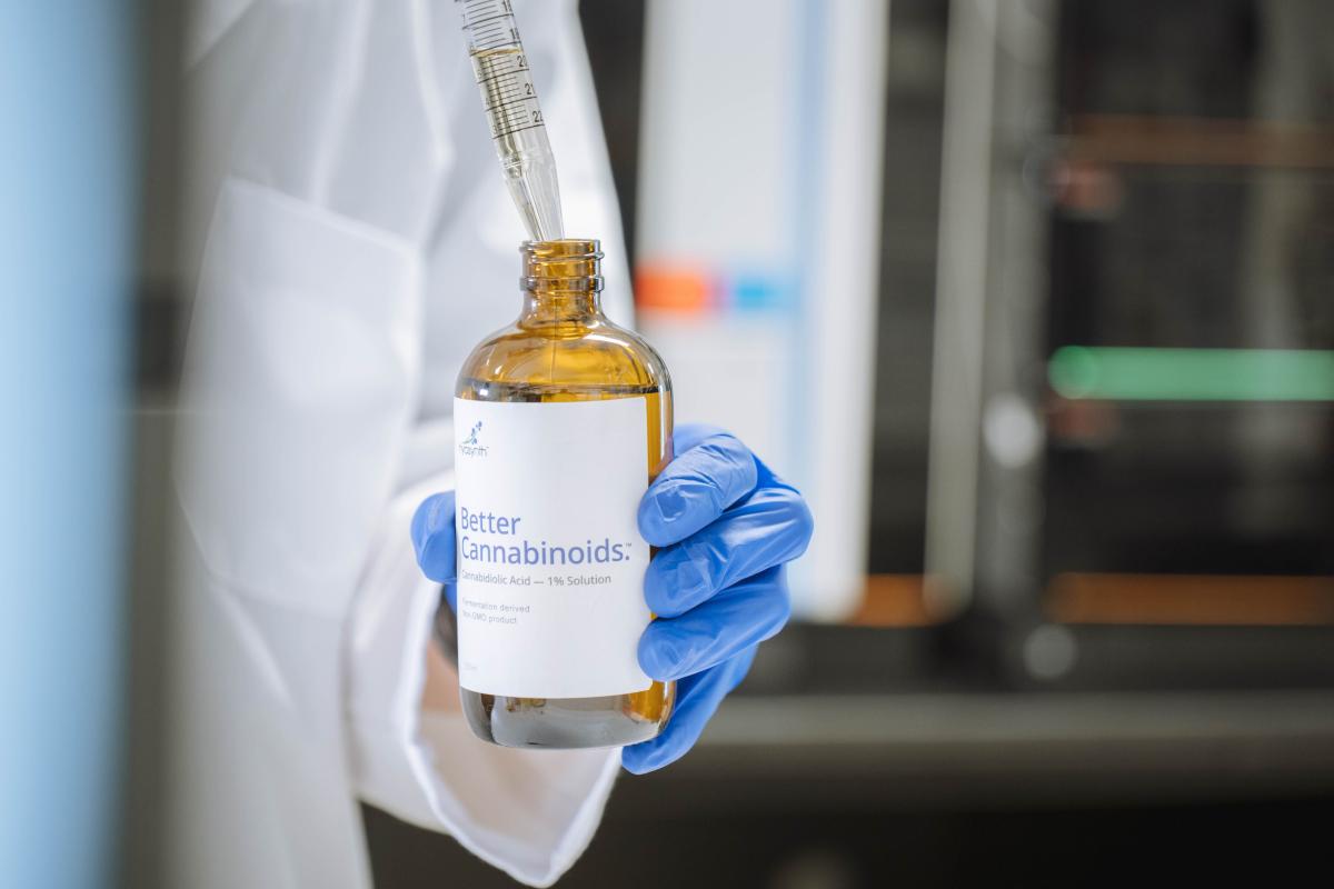 A glass bottle with the label "Better Cannabinoids" being filled up through a dropper.