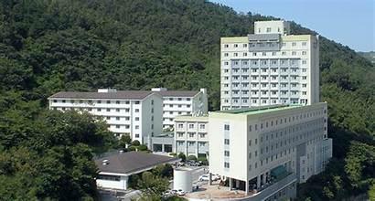 A group of white buildings with trees in the background

AI-generated content may be incorrect.