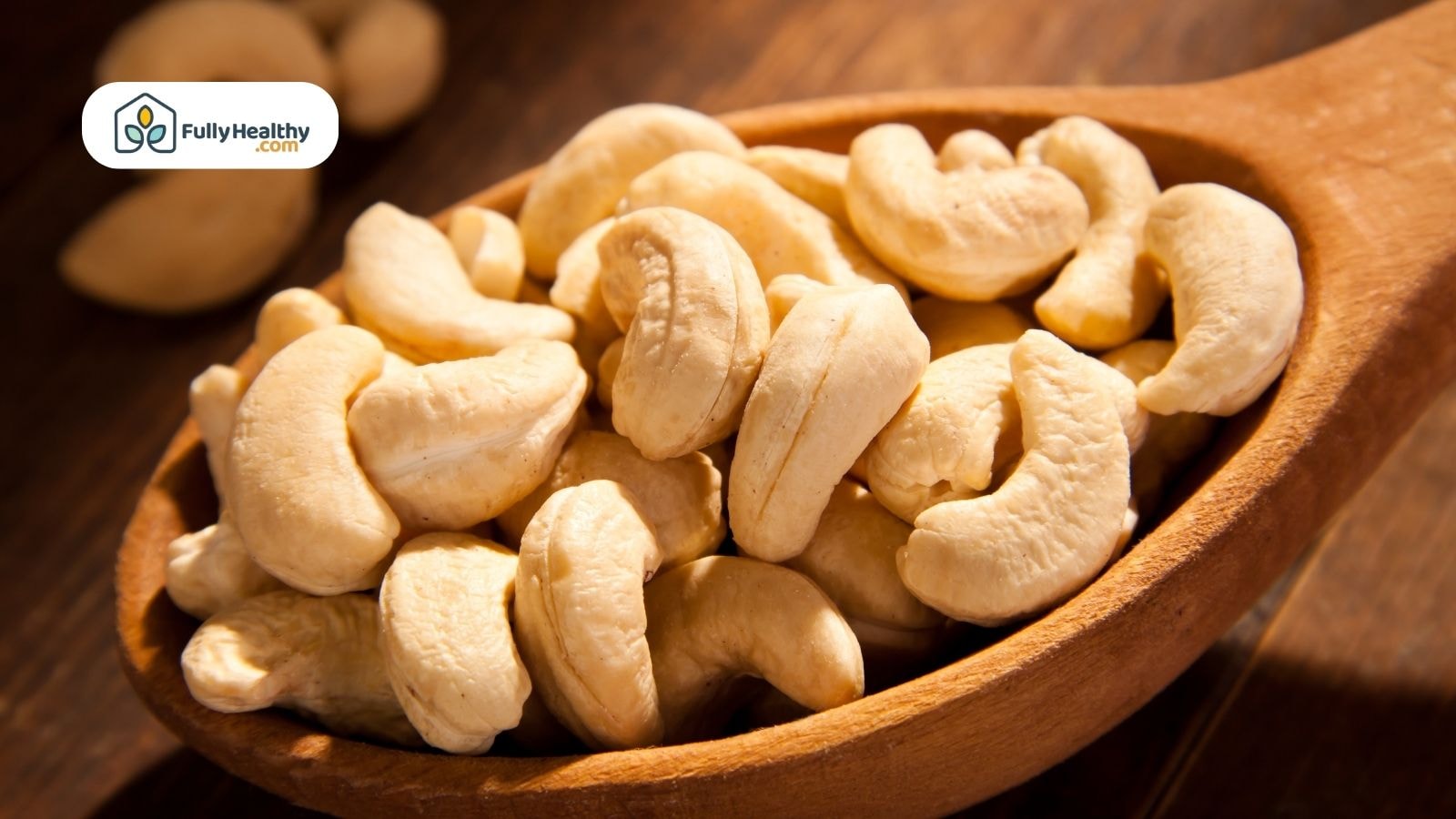 A spoon full of raw cashew nuts