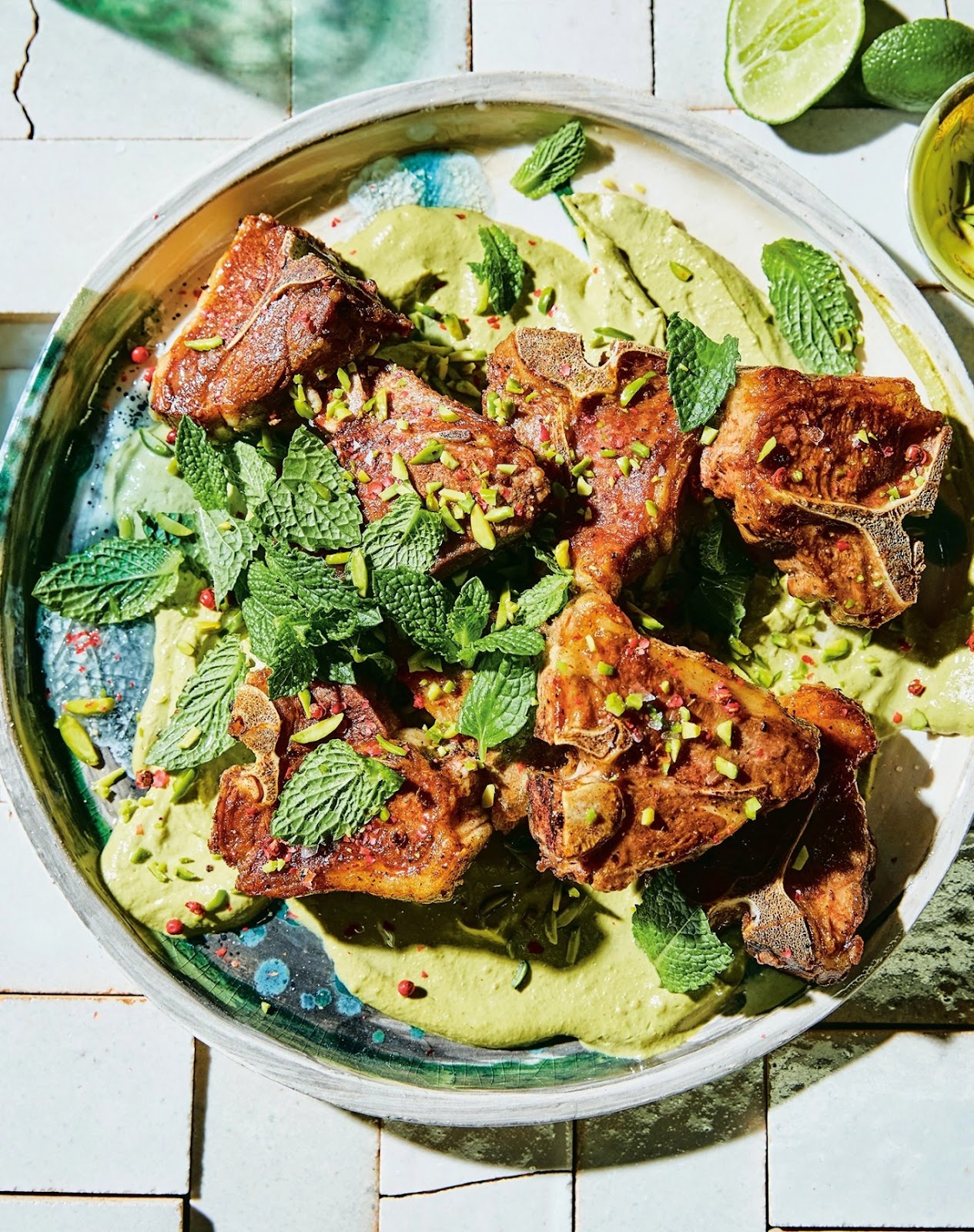 passover recipes: lamb loin chops atop pistachio mint butter, on a serving platter