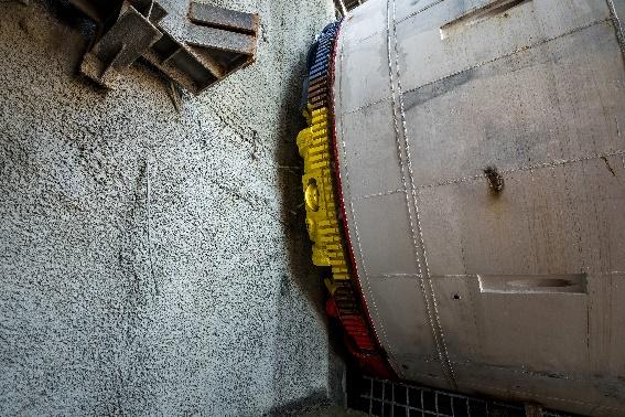 A large metal cylinder with yellow and blue objects  Description automatically generated