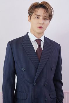 A picture of JYJ's Junsu on a navy blue suit with stripes 