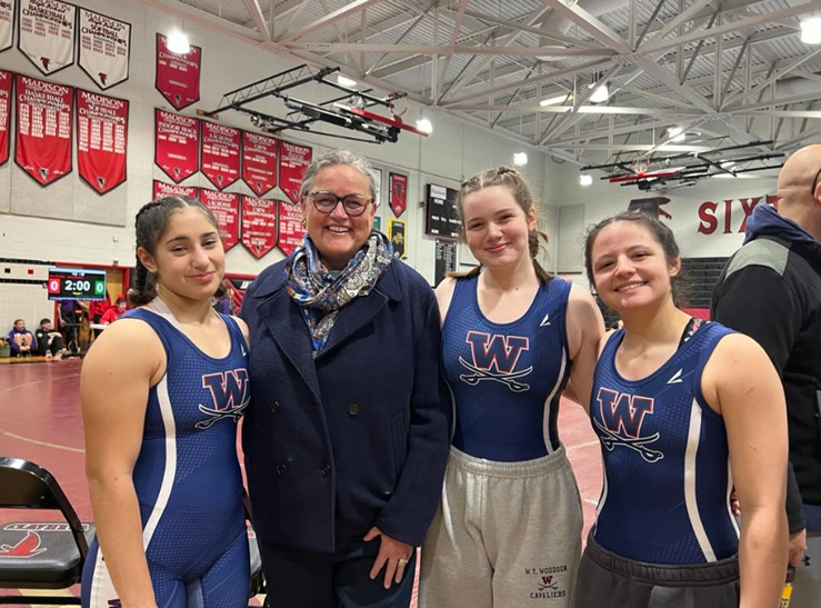 Dr. Reid with three female wrestlers from Woodson High School. 