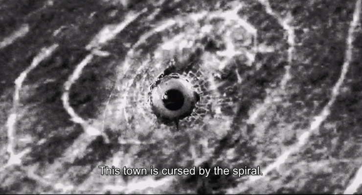 A black and white image of a spiralDescription automatically generated