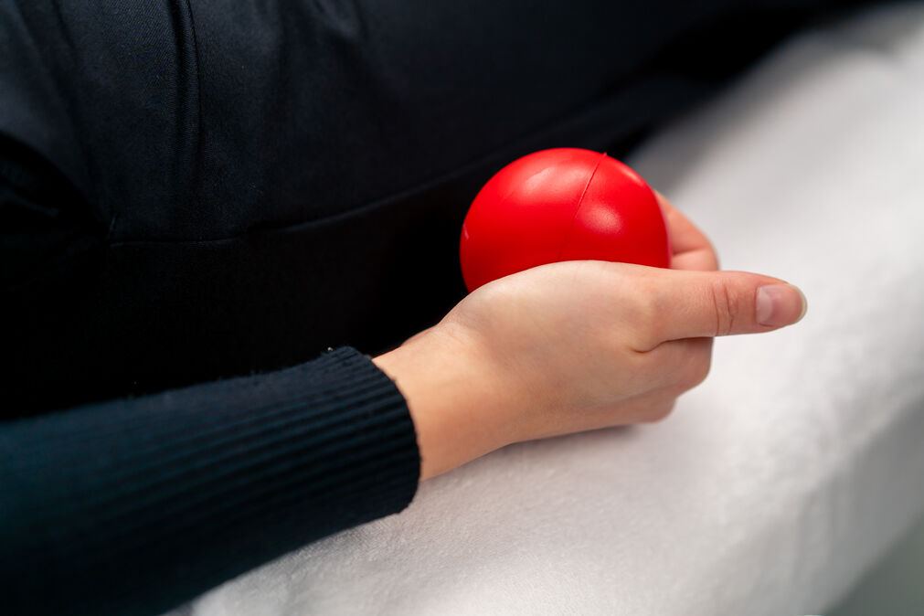 Valgus Extension Overload Exercise - lady pressing a stress ball