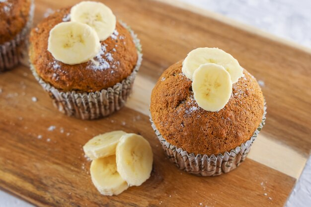 two muffins with bananas on top