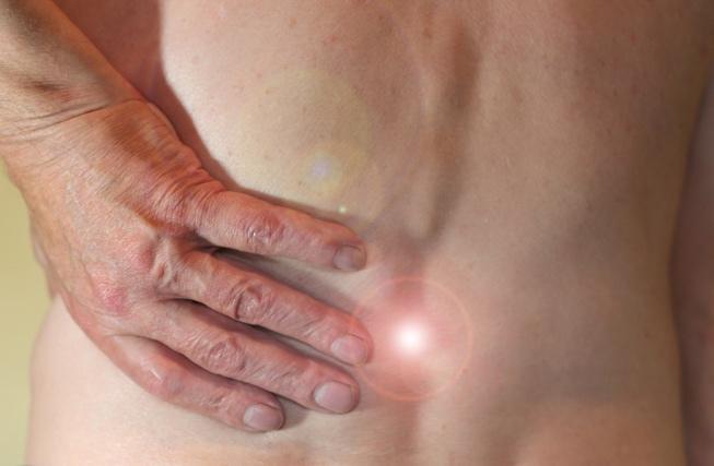 Pain spot in the lower back, representing the need for effective pain relief treatment such as physical therapy or chiropractic care in NYC
