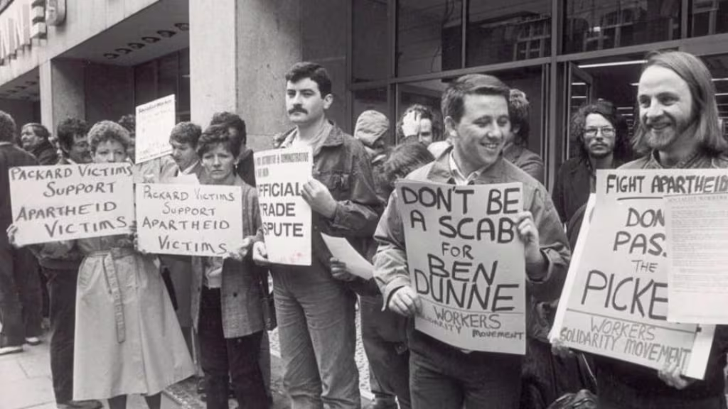 A group of people holding signs

Description automatically generated