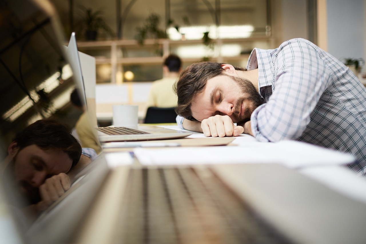 A man sleeping in his laptop - Fast Job Search