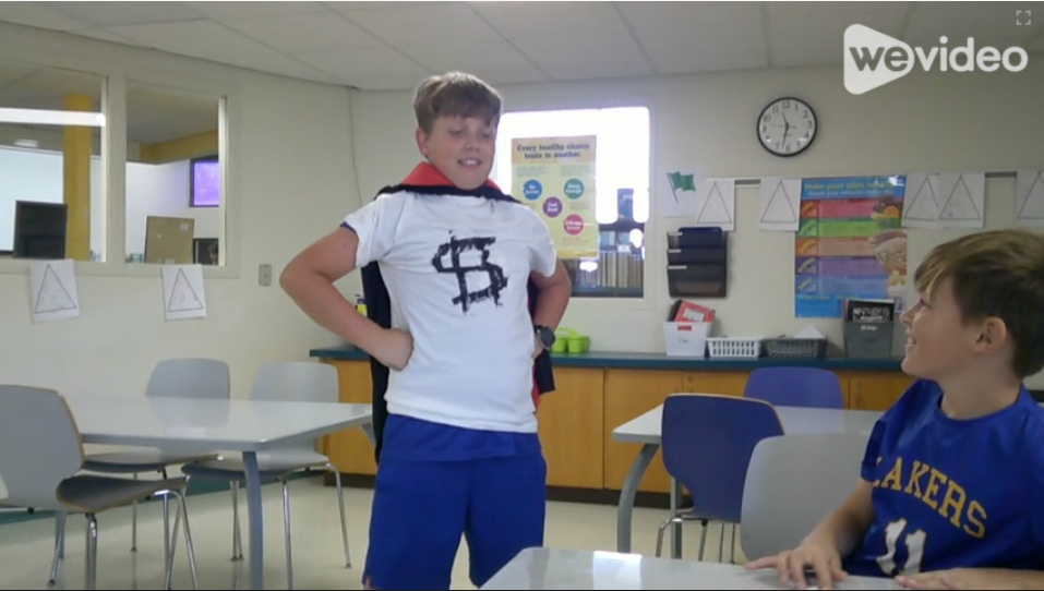 Sam S. transforms into “Money Man” in his Student Council Treasurer campaign video. Dressed in a white shirt with a money symbol and cape.