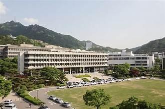 A large building with many windows and parking lot

AI-generated content may be incorrect.