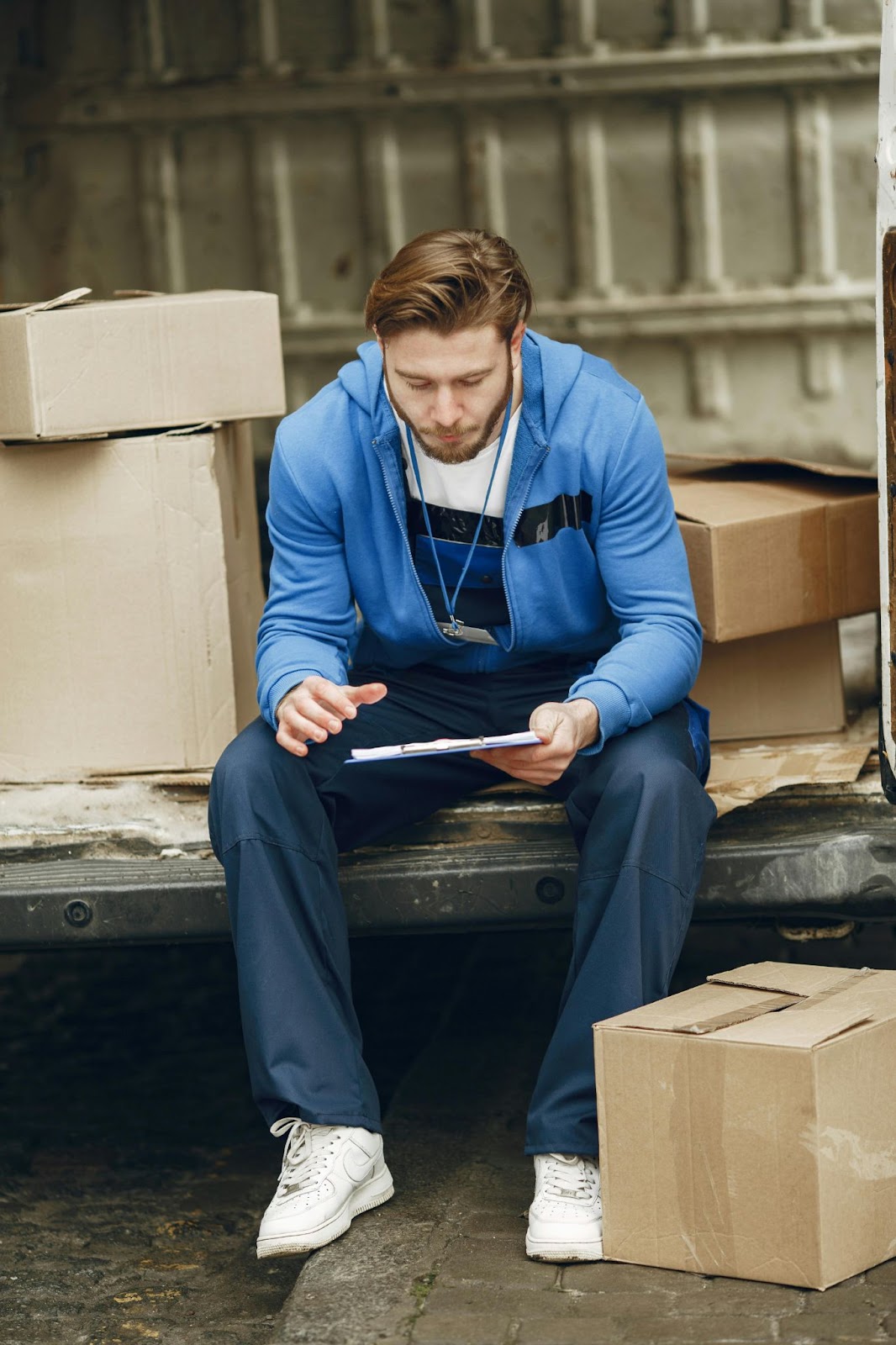 young man sitting down with employee attendance tracking software on iPad 