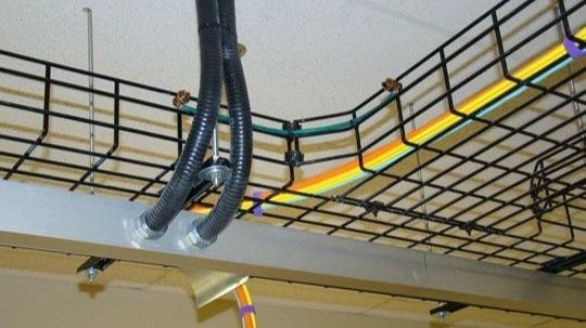 An overhead shot of color-coded Ethernet runs neatly bundled in a data-center ladder rack.