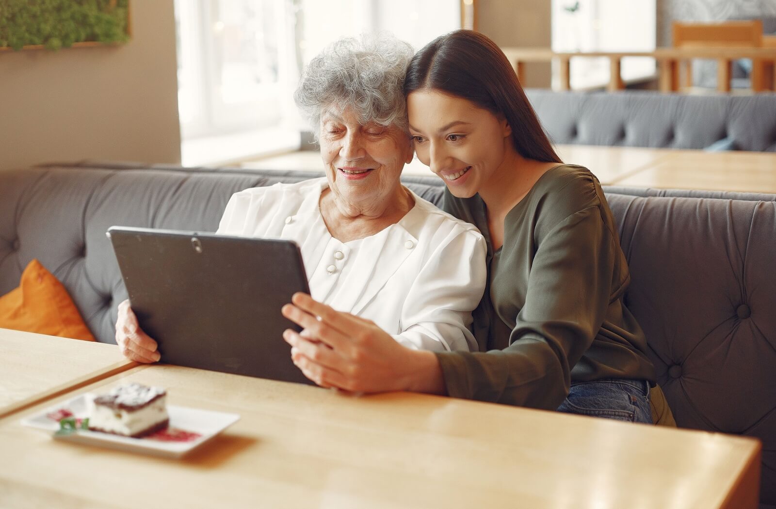 Someone reads with their senior loved one.