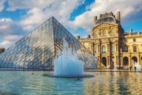 A glass pyramid and LouvreDescription automatically generated