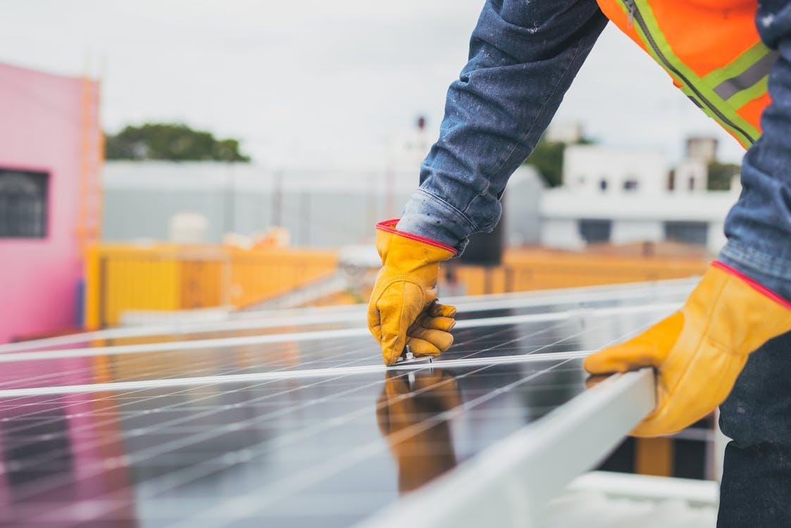 Free Selective Focus on Maintenance Man Installing Solar Panel Stock Photo