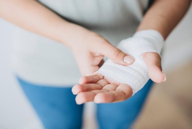 Woman with gauze bandage wrapped around her hand