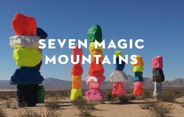 A group of colorful rocks in a desert
Description automatically generated