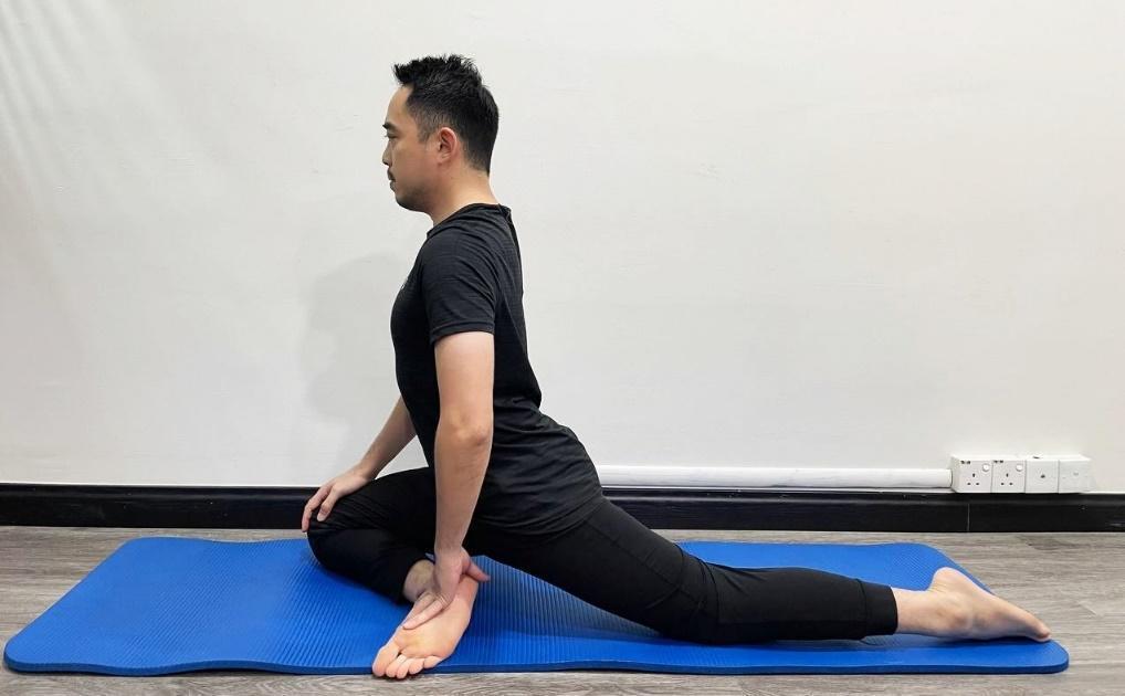 A person sitting on a yoga mat

Description automatically generated with medium confidence