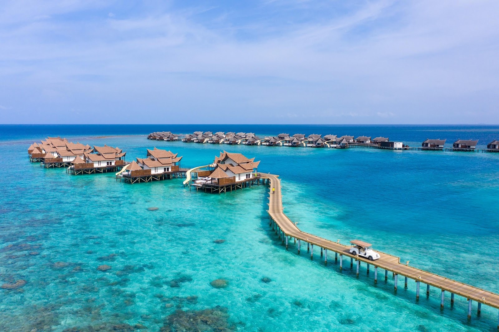 A group of houses on stilts in the water

Description automatically generated