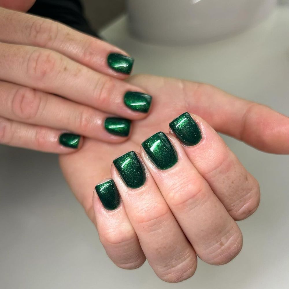 Close up of hands with Christmas Green Nails having  Emereld Glitter Glam