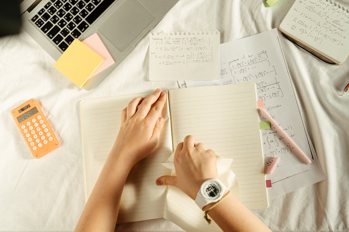 Person Tearing A Page from Notebook
