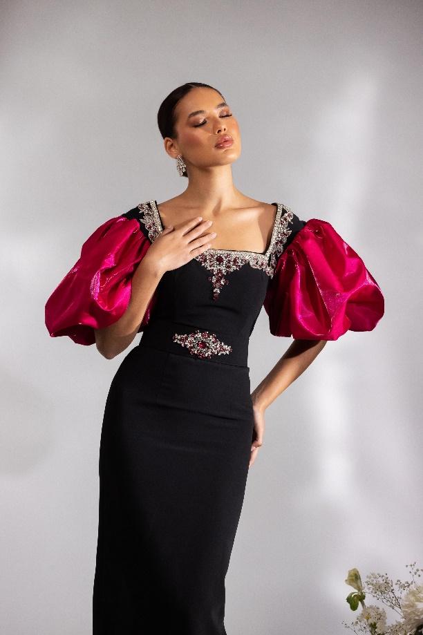A person in a black dressAI-generated content may be incorrect.