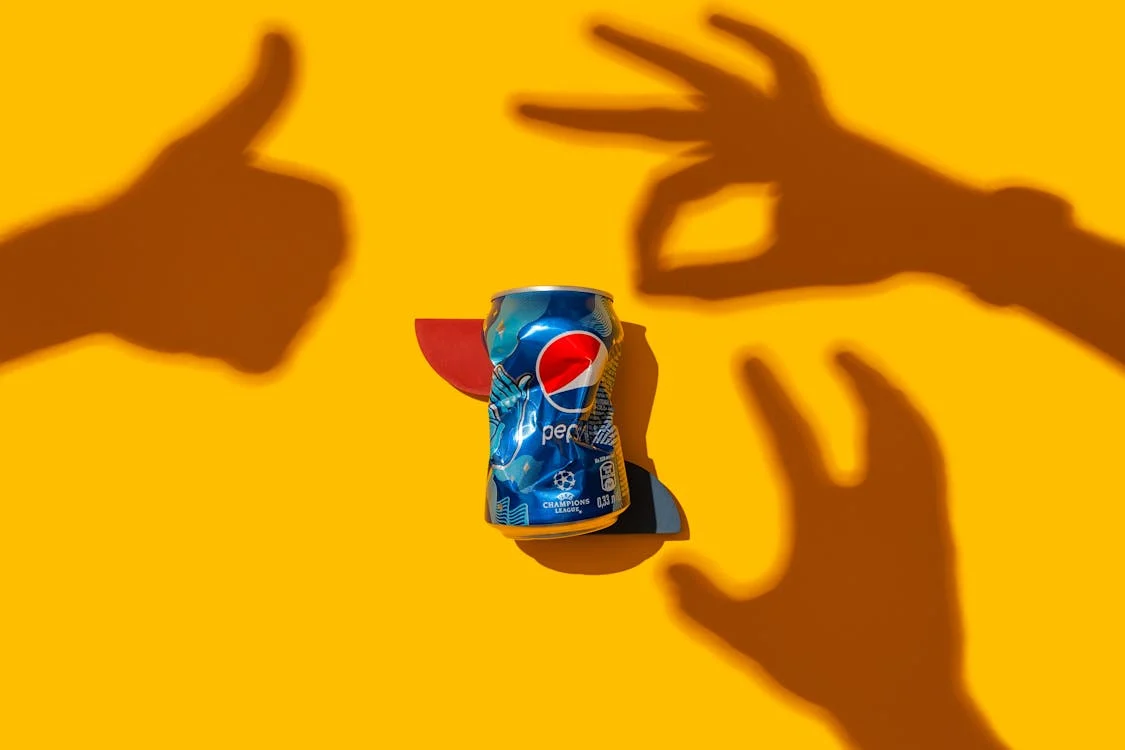 PepsiCo stock analysis 2025 with crumpled Pepsi can and yellow background, symbolizing market trends and investment opportunities.