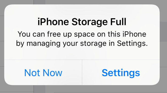 iPhone storage full notification with options to manage storage or dismiss alert.