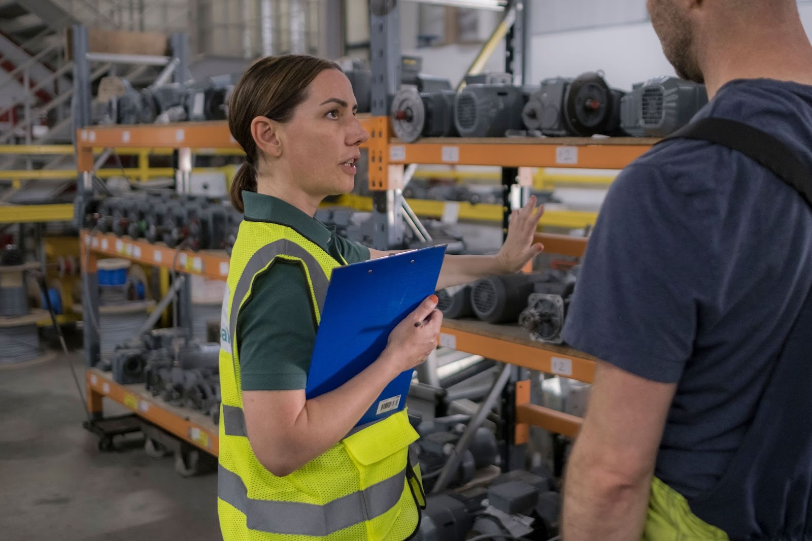An ergonomics consultant conducts a RULA assessment on a worker performing a repetitive task.