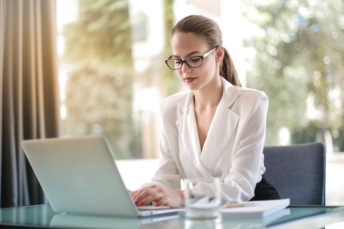 A real estate agent working on a laptop