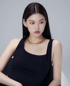 This contains an image of Doyeon putting on black dress