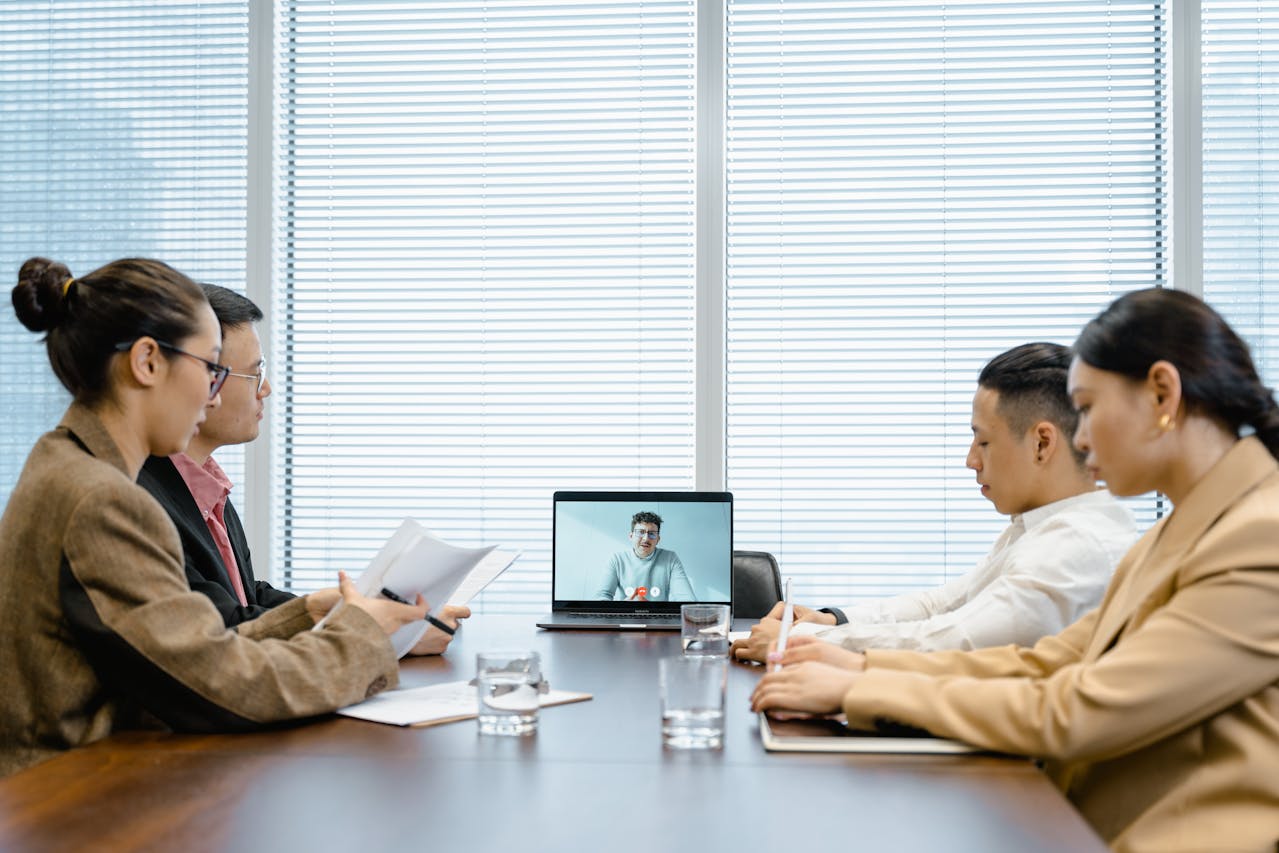 Team members in a conference room conducting a virtual meeting to improve team communication.