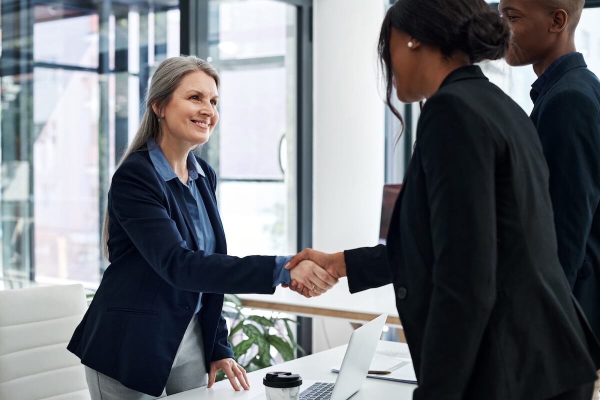 Employee retention strategies: HR manager shaking hands with an applicant