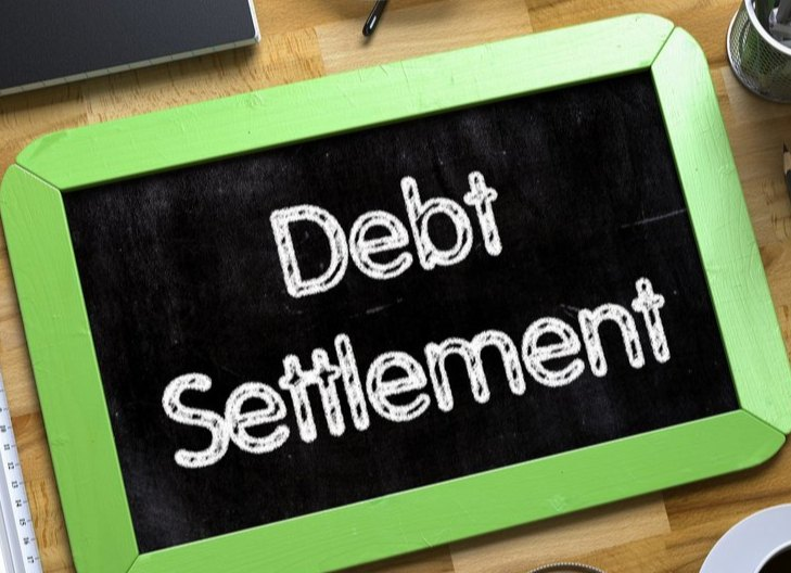 in this image the statement of debt settlement is written on the board. 